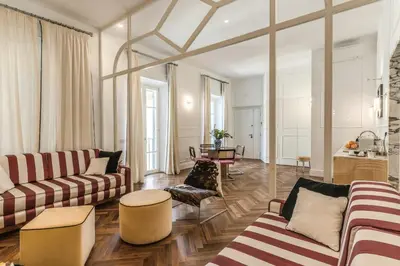 a living room with two couches and a table at Piazza Venezia Luxe Apartment in Rome