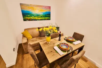 a living room with a table and a couch at Vatican Meadows Apartment in Rome