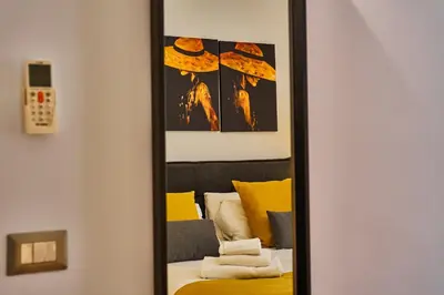a mirror in a room with a bed at Vatican Meadows Apartment in Rome