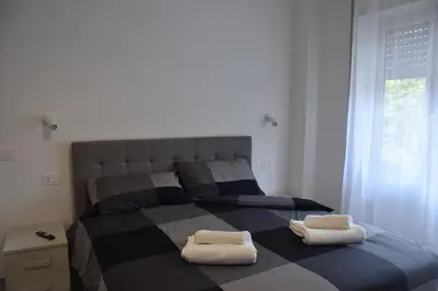 a bedroom with a large bed with two pillows on it at Casa Vacanza SADAMA in Rome