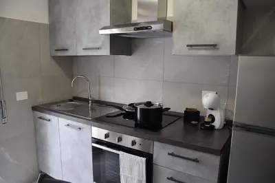 a kitchen with a stove with a pot on it at Casa Vacanza SADAMA in Rome