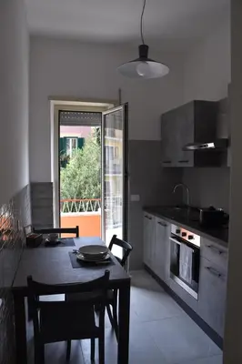 a kitchen with a table and chairs and a window at Casa Vacanza SADAMA in Rome