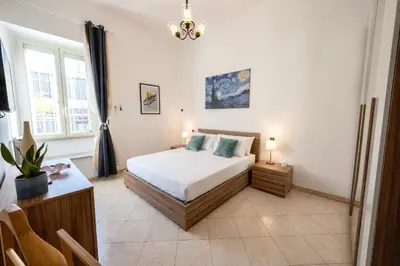 a bedroom with a bed and a table and a window at Exquilia Home & Garden at the Colosseum in Rome
