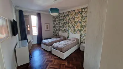 a bedroom with two beds and a couch at Re di Roma vacation in Rome
