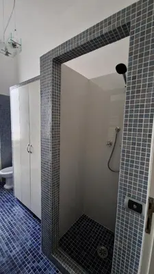 a bathroom with a shower with a mirror at Re di Roma vacation in Rome