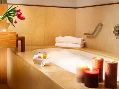 a bathroom with a bath tub with two candles and two candles at Margutta 54 Luxury Suites in Rome