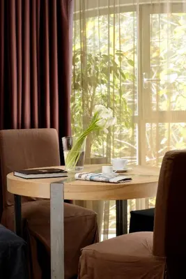 a wooden table with a flower on top of it at Margutta 54 Luxury Suites in Rome