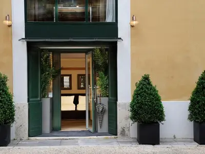 an entrance to a building with a green door at Margutta 54 Luxury Suites in Rome