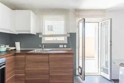 a bedroom with a white bed and a television at Balduina Home in Rome