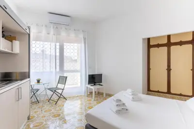 a white room with a bed and a table and chairs at Balduina Home in Rome