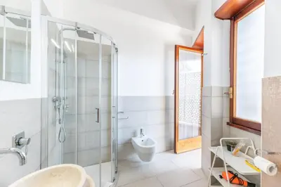 a bathroom with a glass shower and a sink at Balduina Home in Rome