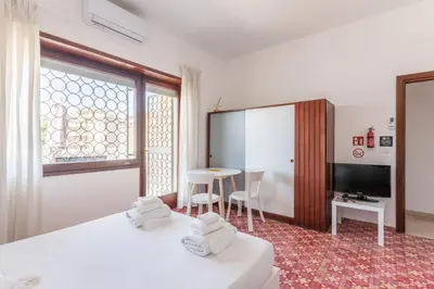a hotel room with a bed and a table and chairs at Balduina Home in Rome