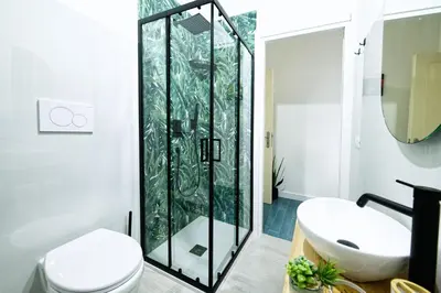 a bathroom with a microwave and a towel on a rack at 3 Passi Da Metro Marconi- 8 min Colosseo in Rome