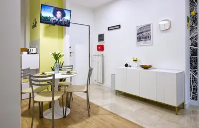 a dining room with a table and chairs and a tv at 3 Passi Da Metro Marconi- 8 min Colosseo in Rome
