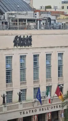 a facade of a building with flags on it at Jolegrè all'Opera in Rome