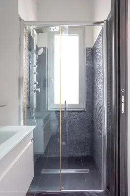 a shower with a glass door in a bathroom at Attic Candia - Vatican Museum in Rome