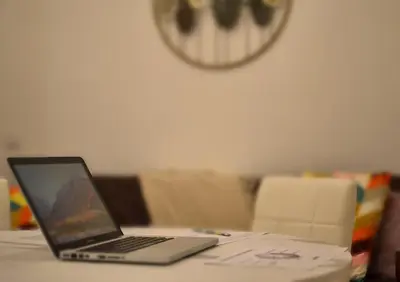 a laptop computer sitting on top of a table at Sophia Luxury Home confortevole e in ottima posizione in Rome