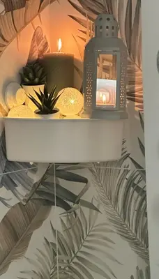 a candle on a shelf with plants and candles at Sophia Luxury Home confortevole e in ottima posizione in Rome