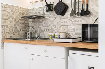 a kitchen counter with a microwave and a sink at La Casina di Luigi con balcone in Rome