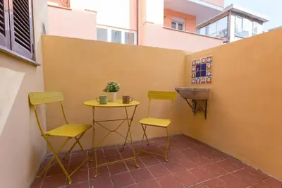 a small table and two chairs on a balcony at La Casina di Luigi con balcone in Rome