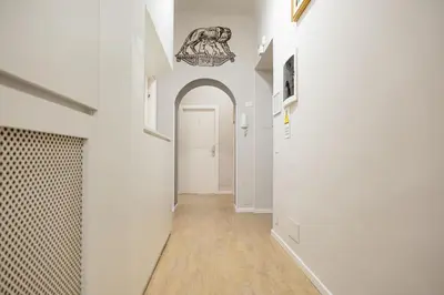 a hallway with white walls and a white door at Bottega Artistica Guest House in Rome