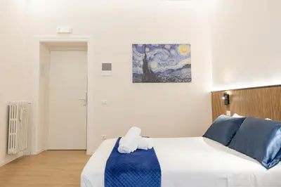 a bedroom with a bed and a painting on the wall at Bottega Artistica Guest House in Rome
