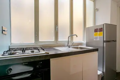 a kitchen with a sink and a refrigerator at Fontana di Trevi a 2 passi in Rome