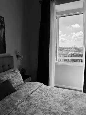 a bedroom with a bed and a large window at Talamo Heritage in Rome