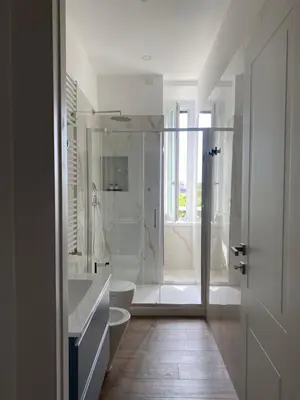 a white bathroom with a toilet and a shower at Talamo Heritage in Rome