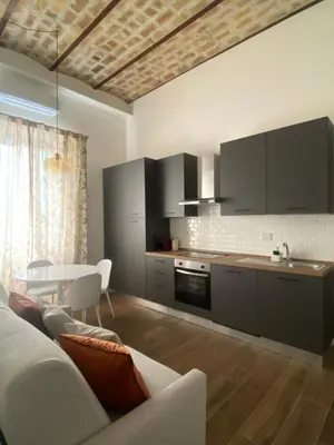 a kitchen with a couch and a table in a room at Talamo Heritage in Rome