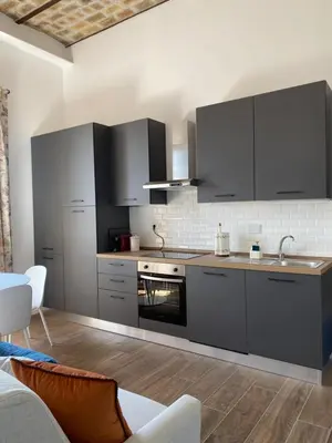a kitchen with gray cabinets and a stove at Talamo Heritage in Rome