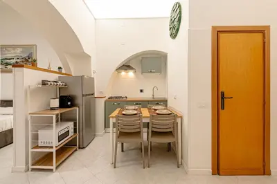 a kitchen with a table and chairs in a room at casa cavour in Rome