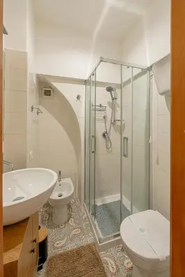 a bathroom with a shower and a toilet and a sink at casa cavour in Rome