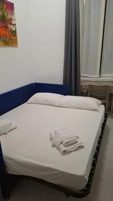 a bed with white towels on top of it at casa cavour in Rome