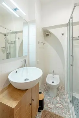 a white bathroom with a sink and a toilet at casa cavour in Rome