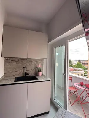 a white kitchen with a sink and a balcony at URBAN CONCEPT Santa Croce in Gerusalemme - Entire apartment in Rome