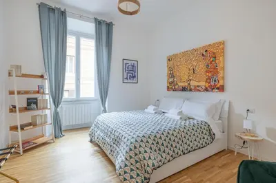 a bedroom with a bed and a painting on the wall at NOSTROMONDO San Cosimato Trastevere Place in Rome