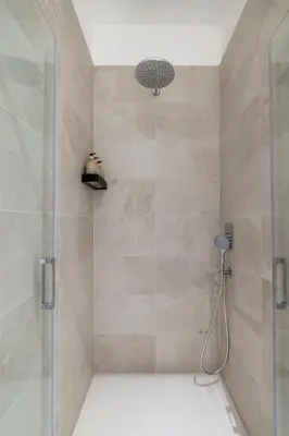 a bathroom with a shower with a glass door at NOSTROMONDO San Cosimato Trastevere Place in Rome