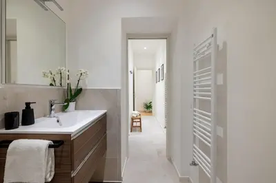a bathroom with a sink and a mirror at NOSTROMONDO San Cosimato Trastevere Place in Rome