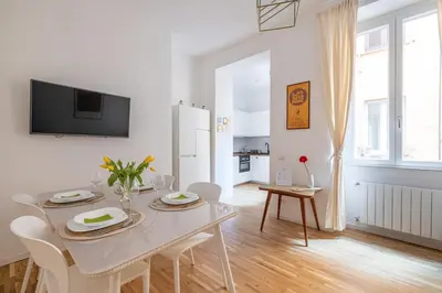 a white dining room with a white table and chairs at NOSTROMONDO San Cosimato Trastevere Place in Rome