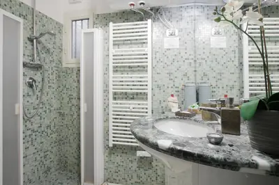 a bathroom with a sink and a shower at Your nest in Trastevere, the heart of Rome - Il vostro Nido nel cuore di Roma in Rome