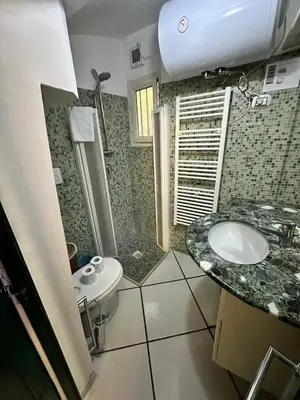 a bathroom with a sink and a shower and a toilet at Your nest in Trastevere, the heart of Rome - Il vostro Nido nel cuore di Roma in Rome