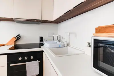 a kitchen with a sink and a microwave at Stylish 1BR, 2BATH Apartment Castel Sant'Angelo 6A in Rome