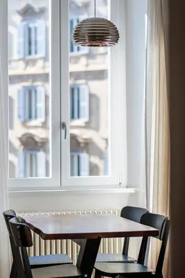 a dining room table and chairs in front of a window at Stylish 1BR, 2BATH Apartment Castel Sant'Angelo 6A in Rome