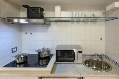 a kitchen with a microwave and a sink at Puccini Flat in Rome