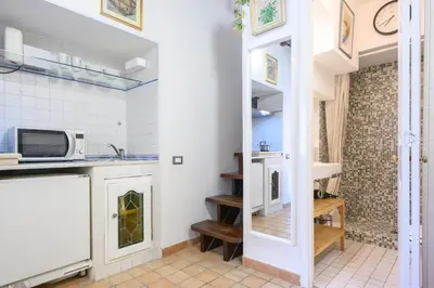 a kitchen with a sink and a microwave at Puccini Flat in Rome