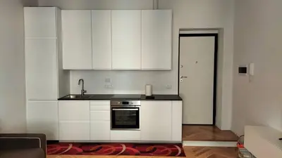 a kitchen with white cabinets and a stove at Catone 34 in Rome