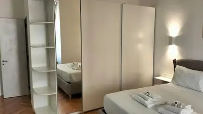 a bedroom with a mirror and a bed with towels at Catone 34 in Rome