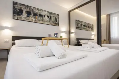 a bedroom with two beds with white towels at Luxury Stay in Rome Steps from Metro A Cornelia in Rome