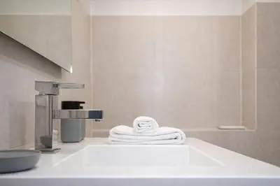a bathroom with a sink and a towel at Luxury Stay in Rome Steps from Metro A Cornelia in Rome